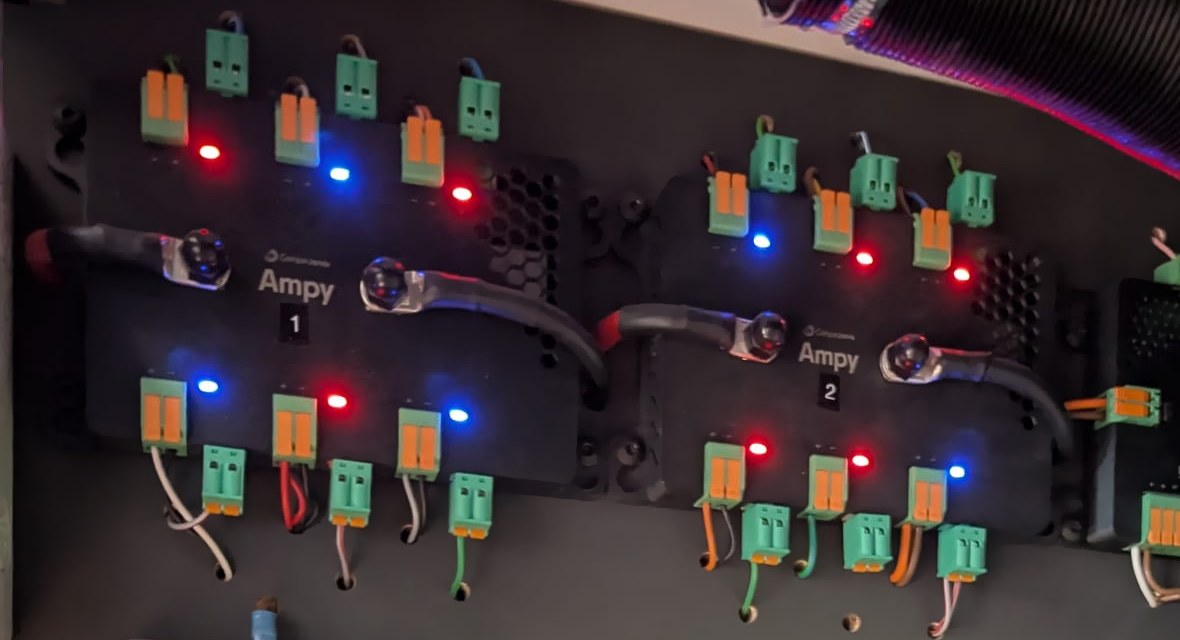 Two Ampys in use. The lights show for each output whether power is on: blue on, red off.
